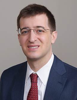 Headshot of a person with a neutral background
